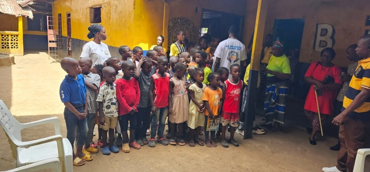 Children in school uniforms gathered in the courtyard of the orphanage in Liberia