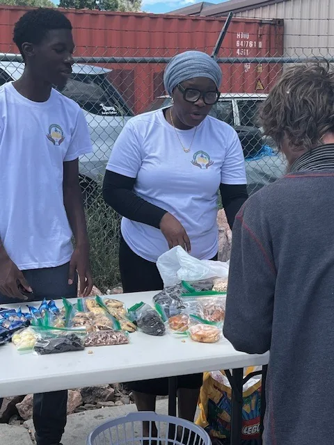 Volunteers serving at an outreach table in Colorado Springs