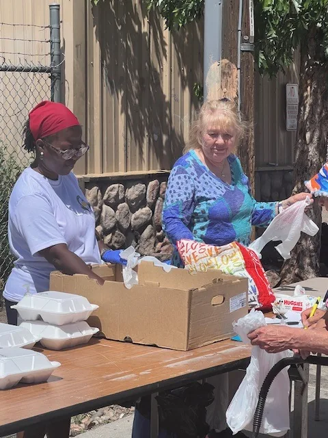 Volunteers serving at an outreach table
