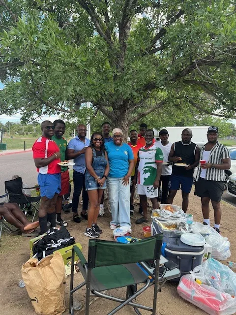 Kyne Hands Foundation volunteers and neighbors gathered under the trees at an outreach