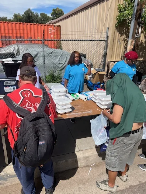 Neighbors collecting meals at the outreach