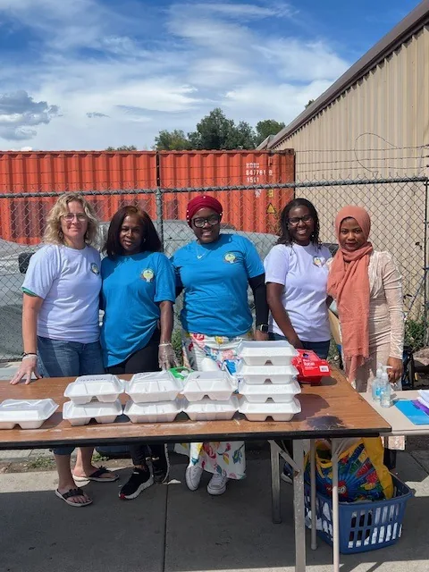 Kyne Hands Foundation volunteers behind a table of meal boxes at an outreach in Colorado Springs