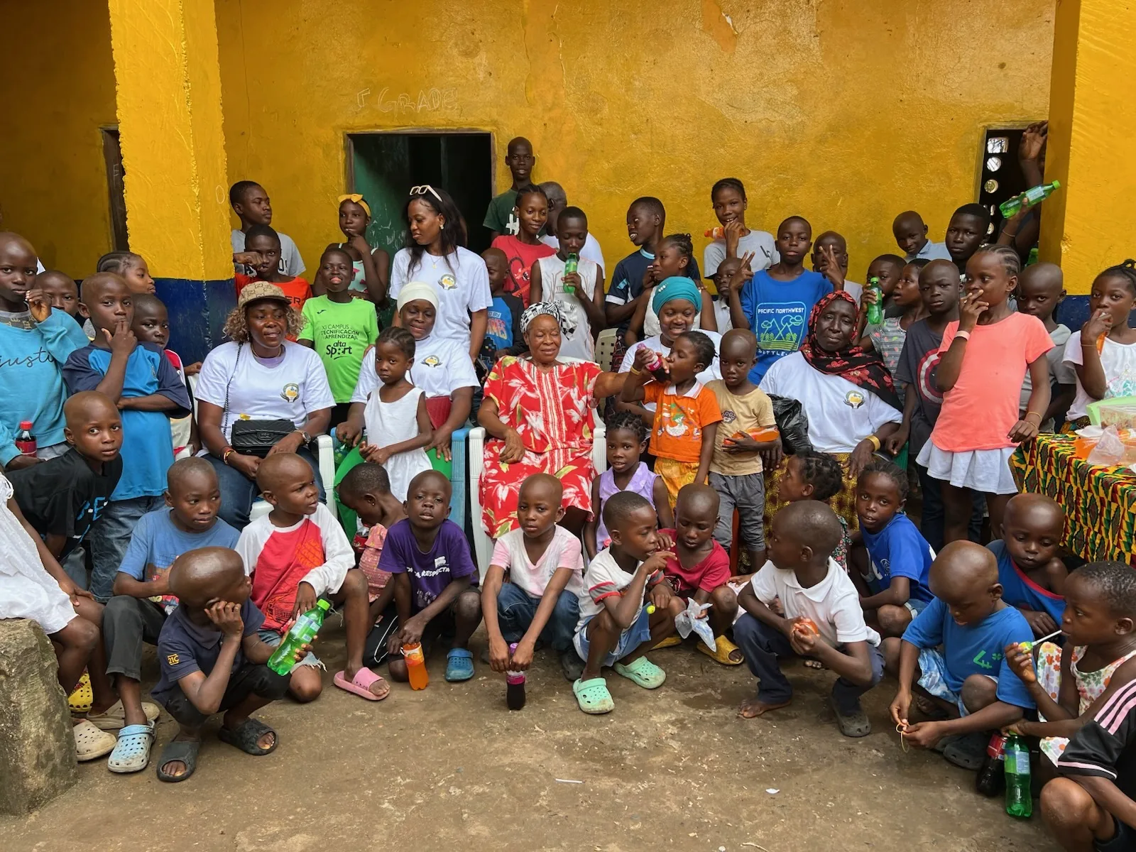 Dozens of children and Kyne Hands Foundation volunteers gathered together in the courtyard of the orphanage in Liberia