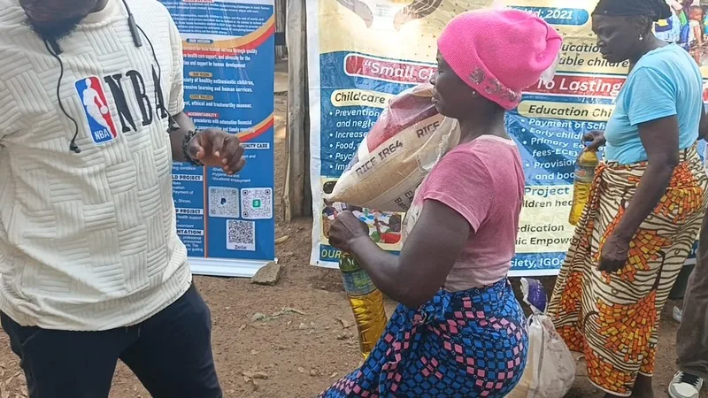 Kyne Hands Foundation volunteers handing food to a family in Liberia