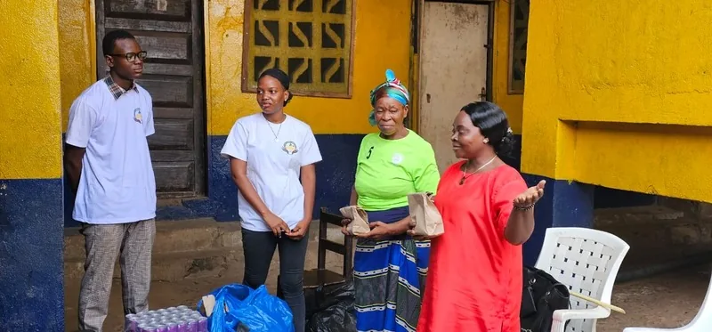 Kyne Hands Foundation partners and volunteers standing together in the orphanage courtyard