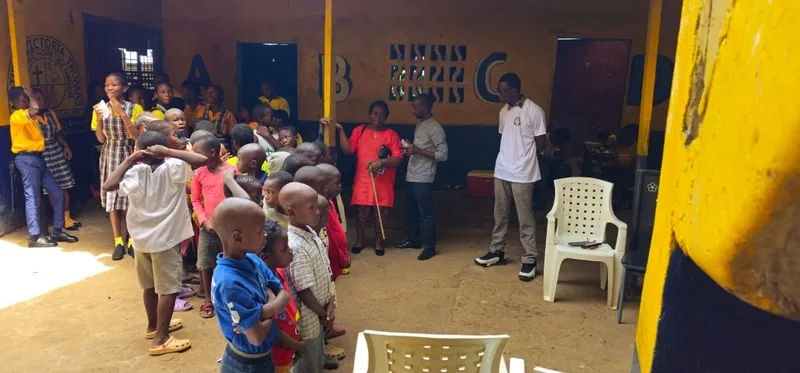 Children and volunteers gathered in the orphanage courtyard