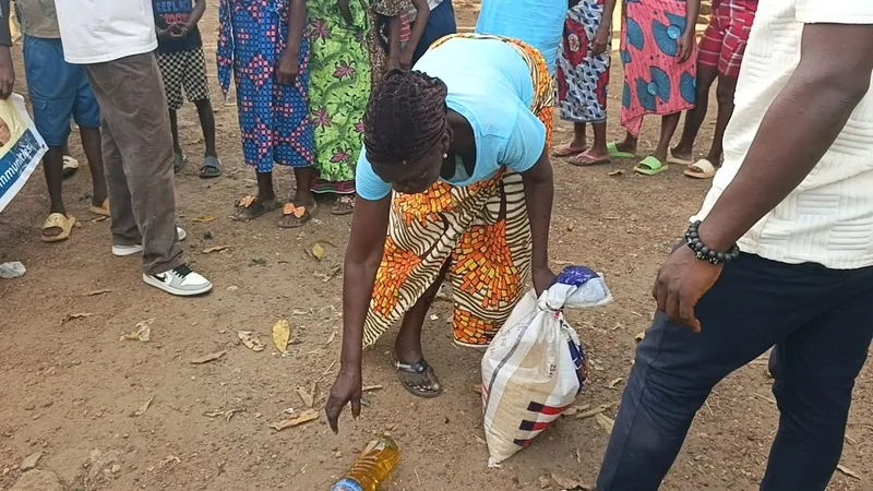 A woman receiving a bag of food at a community distribution