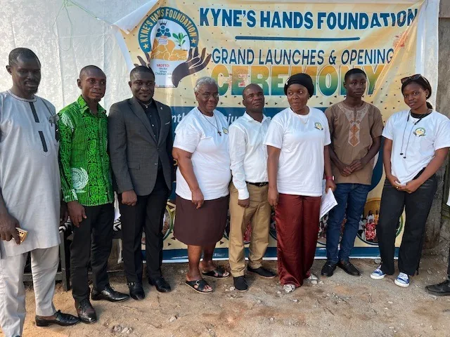 The Kyne Hands Foundation team and guests in front of the banner at the foundation&rsquo;s grand launch in Liberia
