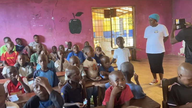 A classroom full of children in Liberia, seated at their desks