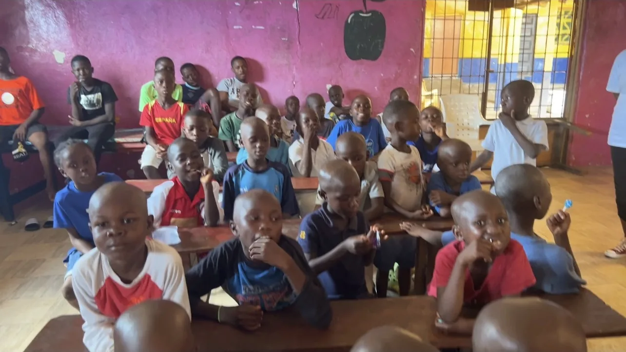 A classroom of children in Liberia listening to a Kyne Hands Foundation volunteer